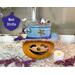 This is a decorative gourd character named Birdie. She is hand-carved with a custom hat made with up-cycled jeans. A candle is included. 